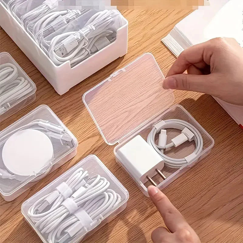 Person opening one of the clear cable boxes in the organizer set, demonstrating how to store a charger and cord