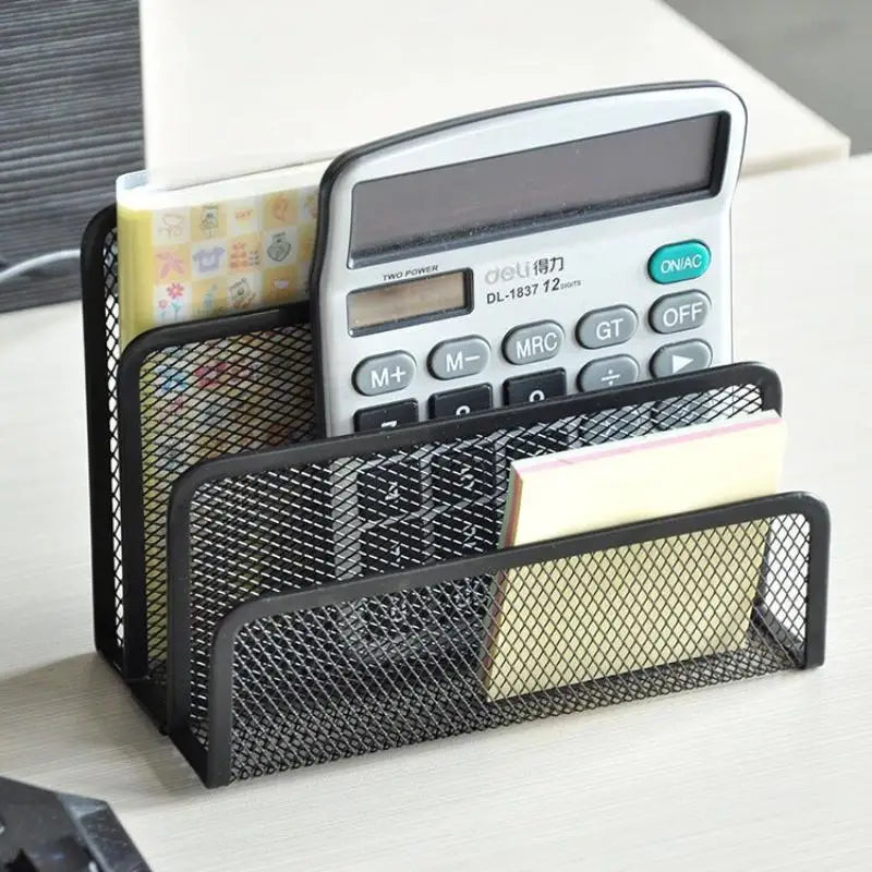 Black mesh letter holder on a desk organizing a calculator, notebooks, and sticky notes