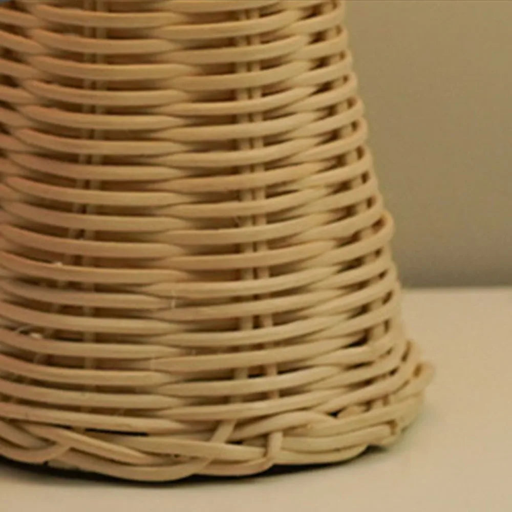 Detail of woven rattan-style lamp base, beige color, texture visible