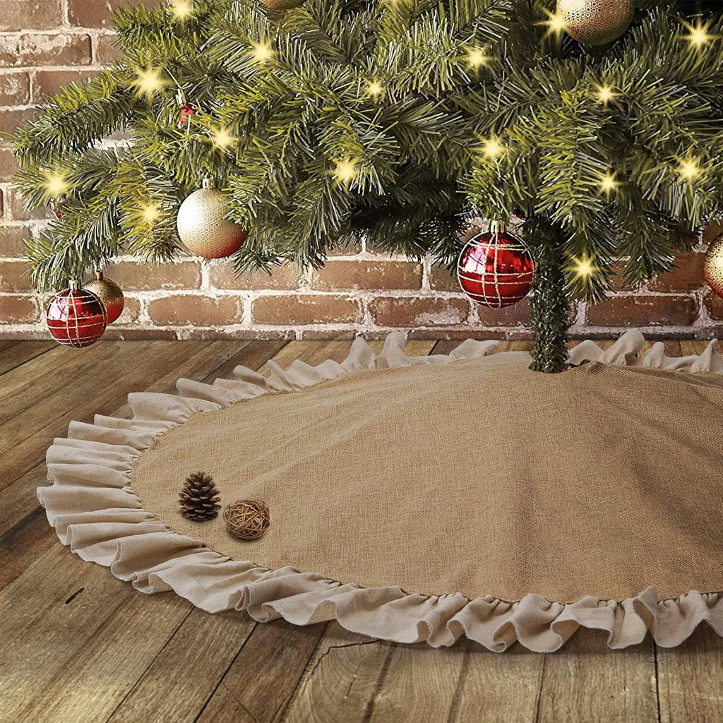 Burlap Christmas tree skirt with ruffle edge under decorated tree in rustic living room