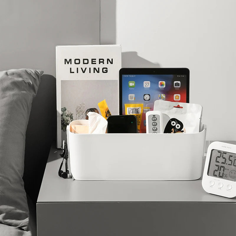 Bedside storage caddy on a nightstand holding tablet, book, remote, and small items