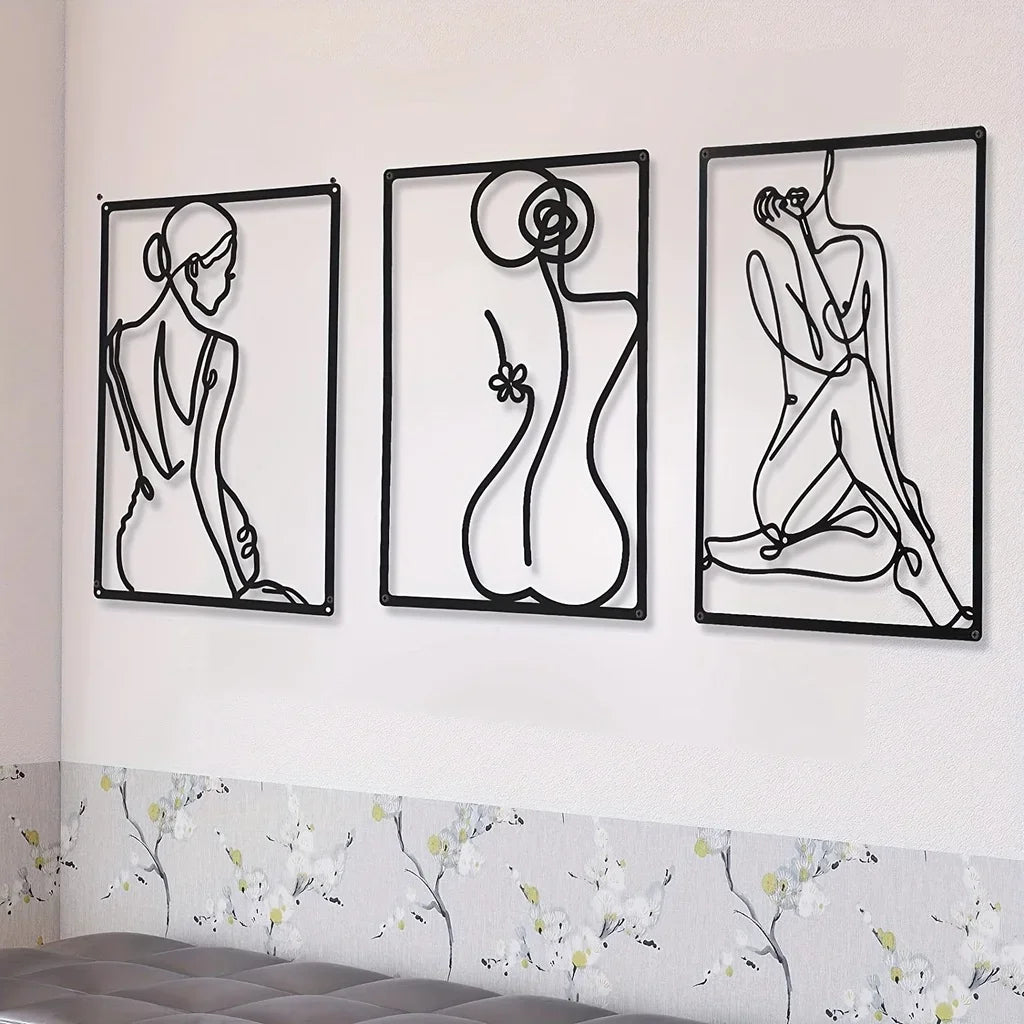 Set of three abstract metal wire wall sculptures in black, displayed on a white wall above a tufted bench with floral wallpaper below.