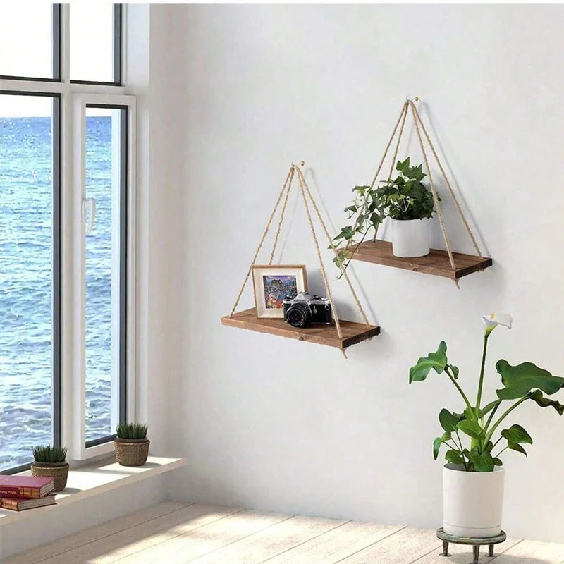 Pair of brown wood rope wall shelves in a bright room with plants and decor