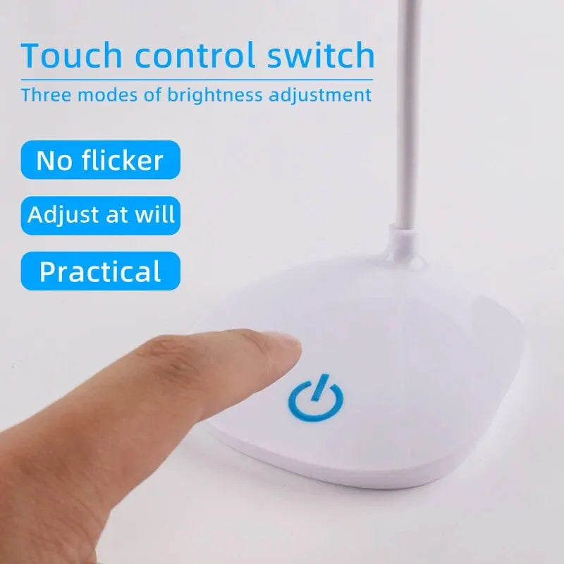 Touch control area of LED desk lamp being activated by a finger, close-up of touch sensor