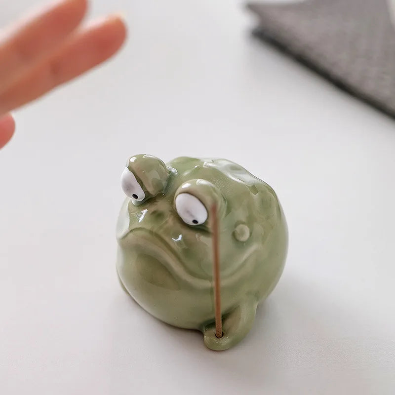 Top view of frog-shaped ceramic incense holder holding an incense stick