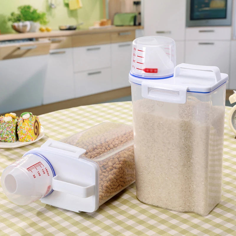Two airtight pet food storage containers in a kitchen—one upright with rice, one on its side with dry beans
