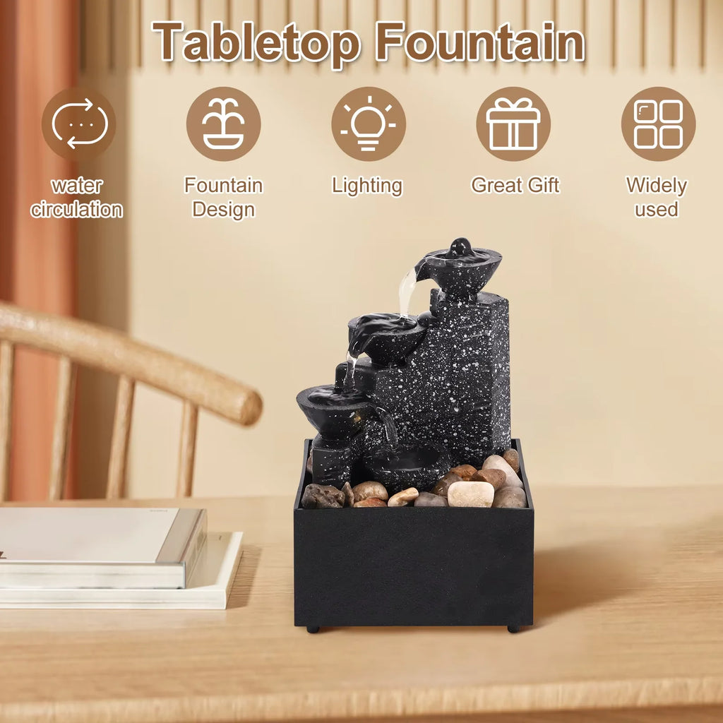 Compact desktop fountain with LED light and pebbles on a wooden surface, surrounded by icons for water circulation, design, lighting, and gift use