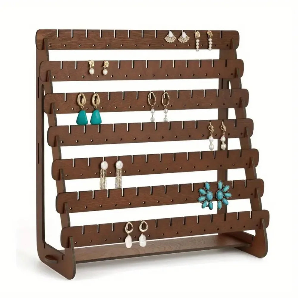 wooden earring display rack with a few earrings, showing side and front details