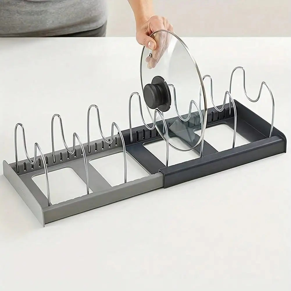 Hand placing a lid onto the adjustable pan and lid organizer rack