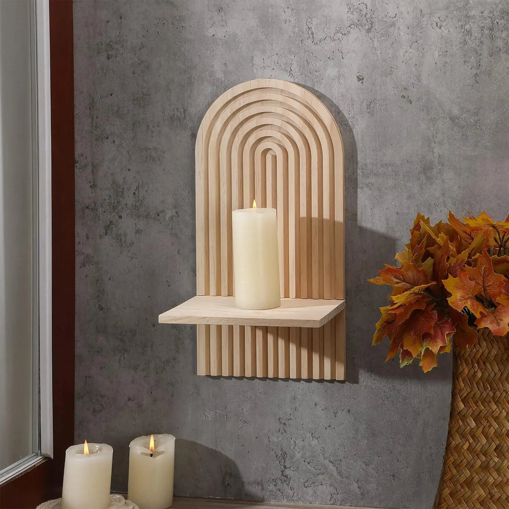 Boho wooden arch wall shelf on concrete wall with candle and autumn decor