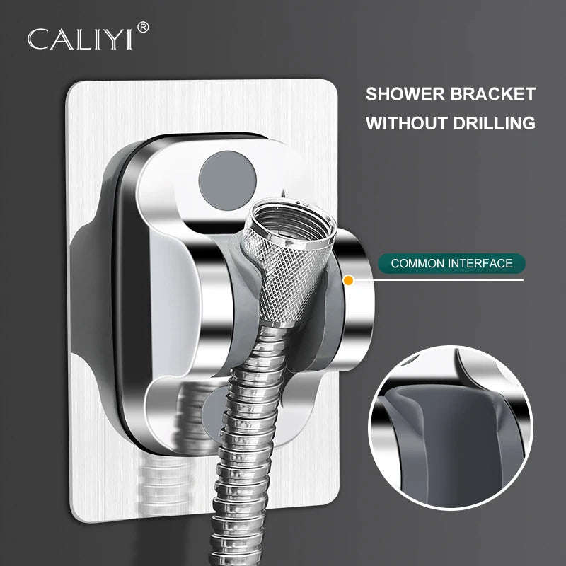 Close-up of self-adhesive shower head holder installed on bathroom wall, silver color