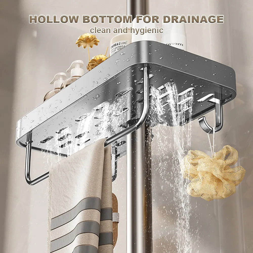 Close-up of water draining through slotted bottom of gray aluminum shower caddy with towel bar and hanging sponge