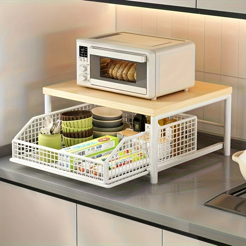 Kitchen countertop appliance shelf with natural top holding a toaster oven, underneath a white pull-out metal basket storing dishes and kitchen supplies