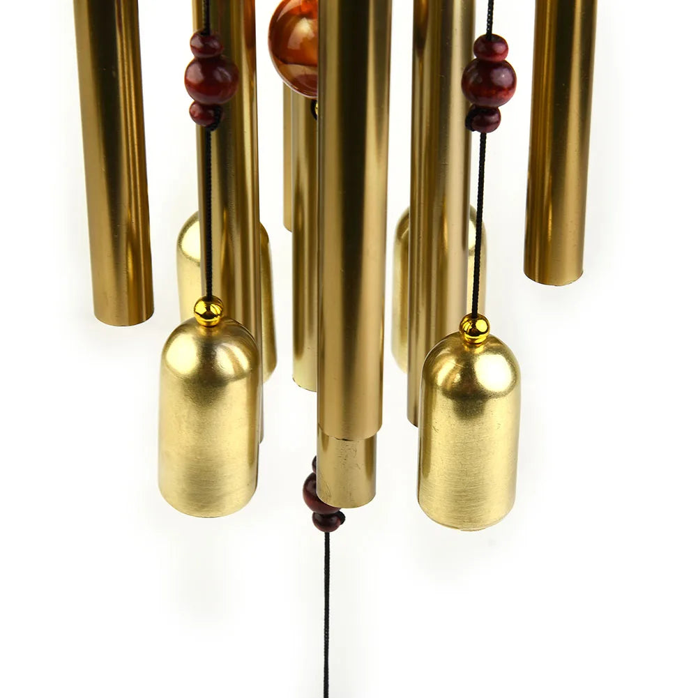 Detail of gold metal bells and tubes on the wind chime