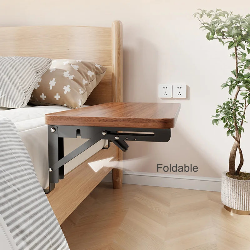 Foldable brown bedside table shelf extended from bed with metal brackets
