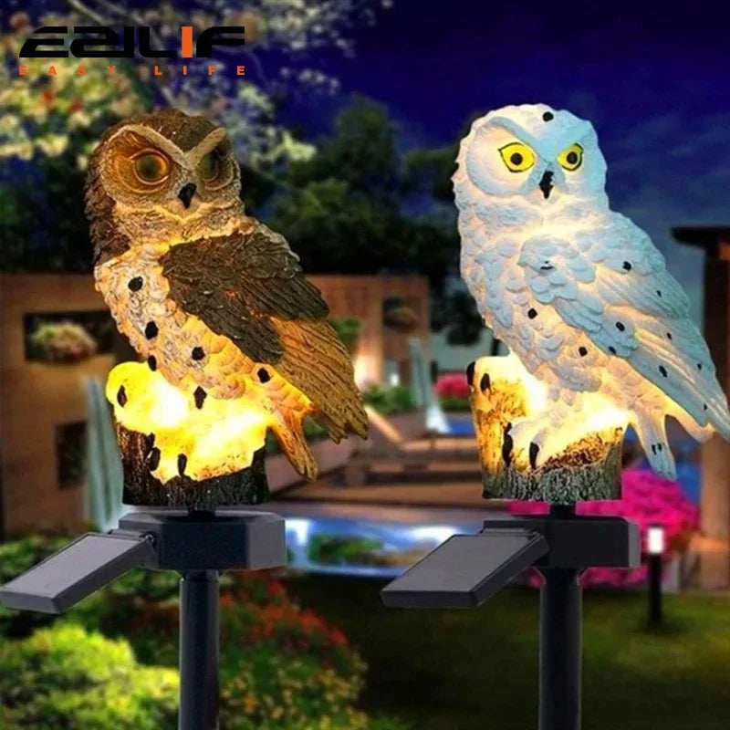 Brown and white owl solar garden lights glowing in an evening garden scene