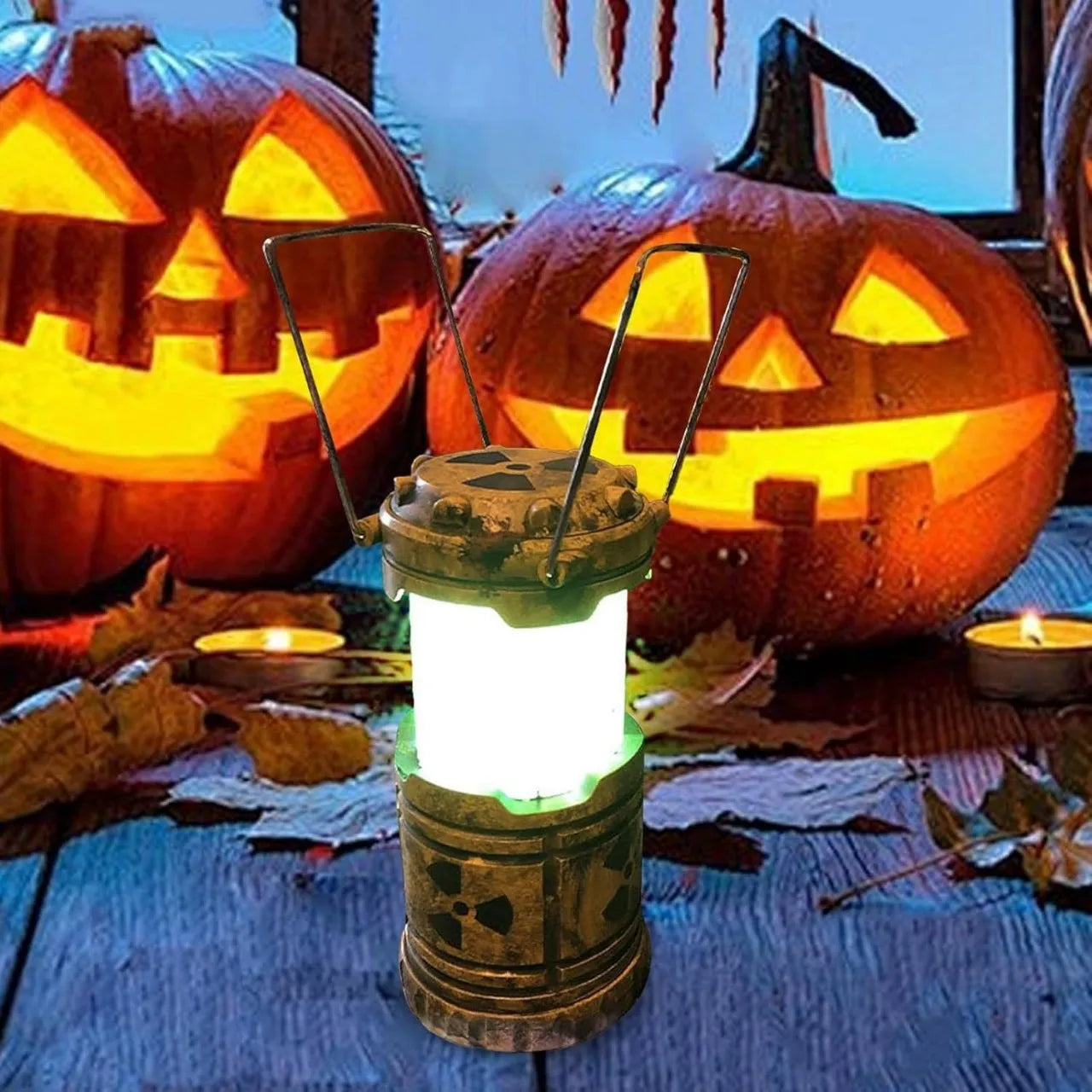 Mini nuclear reactor lantern glowing green on a table with Halloween pumpkins in the background