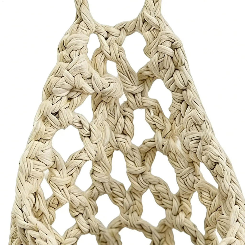Close-up of woven cotton macrame pattern in natural white