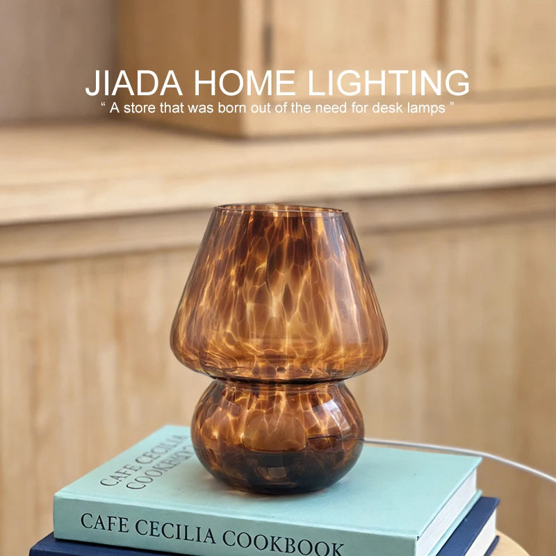 close-up of coffee patterned mushroom glass lamp on a book stack