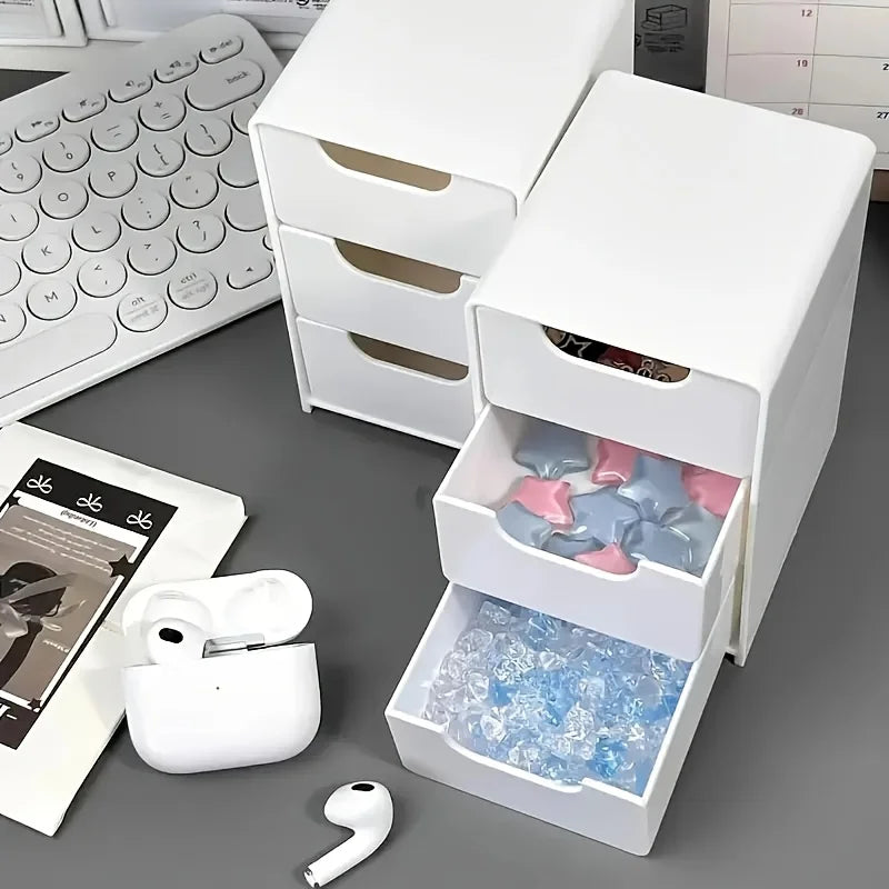 White plastic mini drawer organizer holding assorted small items and accessories