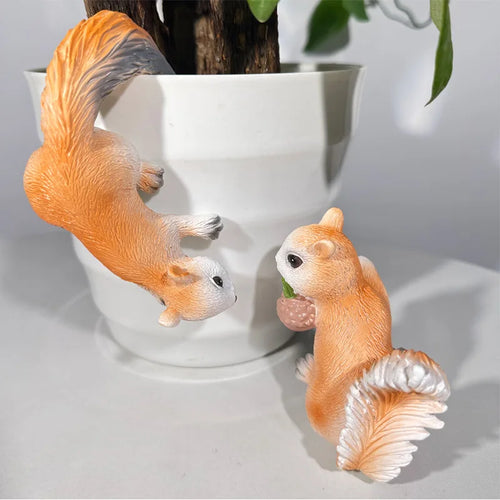 Resin squirrel planter decor set shown on and next to a white flower pot