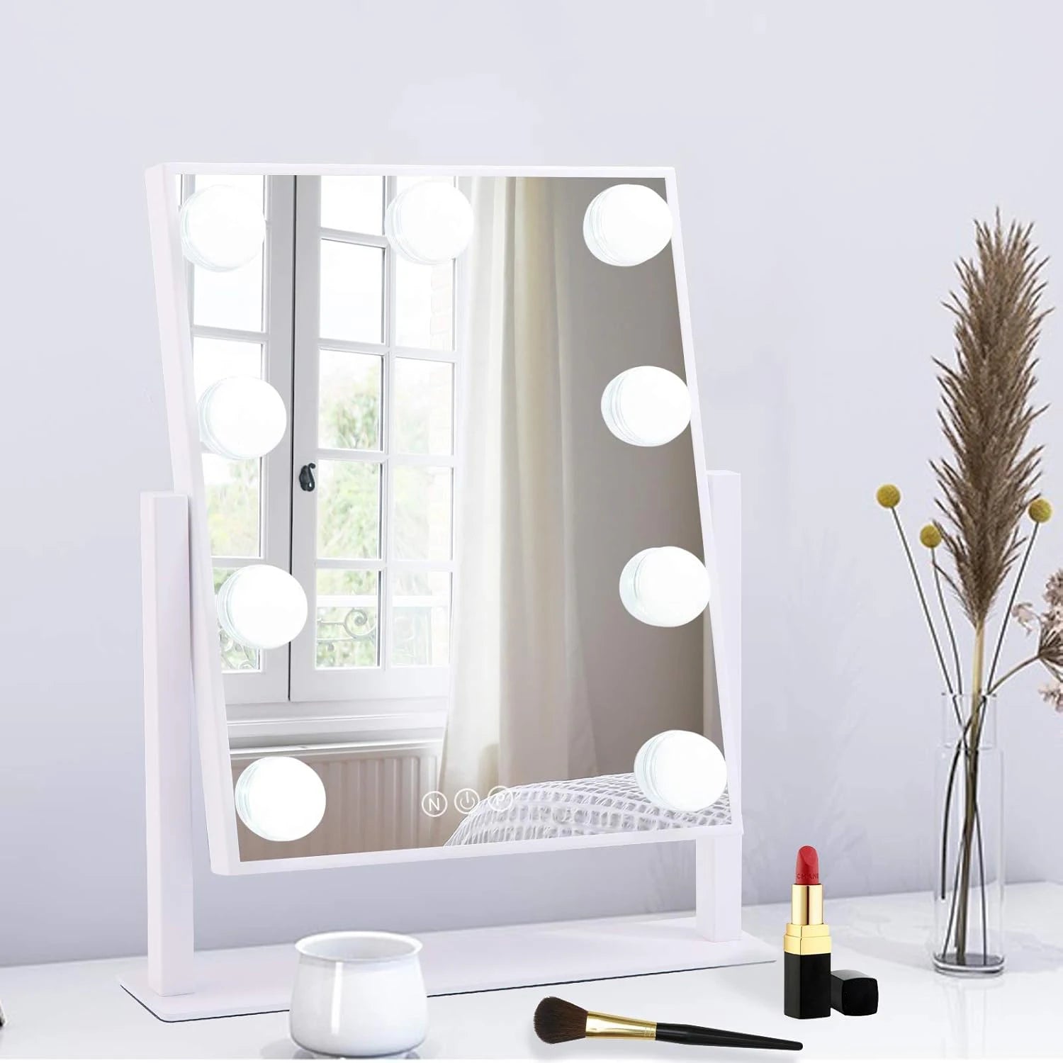 white lighted vanity mirror on bedroom dressing table with makeup accessories