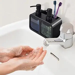 Black dual soap dispenser set on a bathroom sink countertop, with toothbrushes in the brush slot