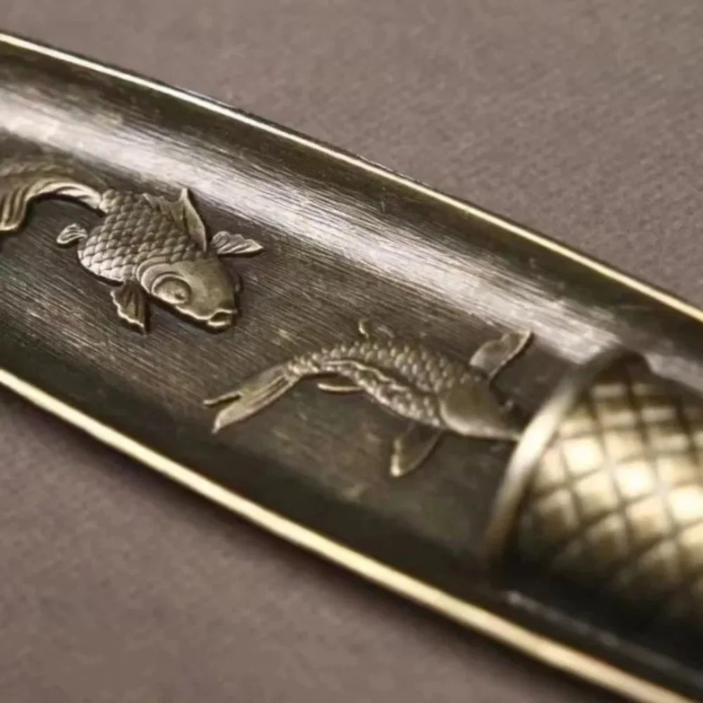 Close-up of koi fish design detail in the boat incense holder