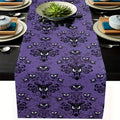 Purple linen Halloween table runner with haunted ghost pattern on dark dining table setting
