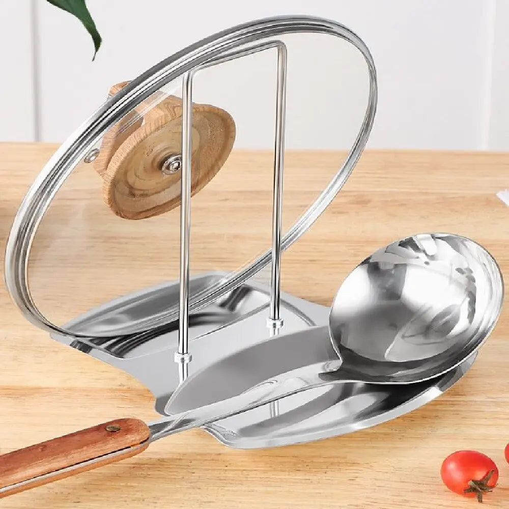 Stainless steel kitchen organizer holding a glass lid and a metal ladle on a wooden counter