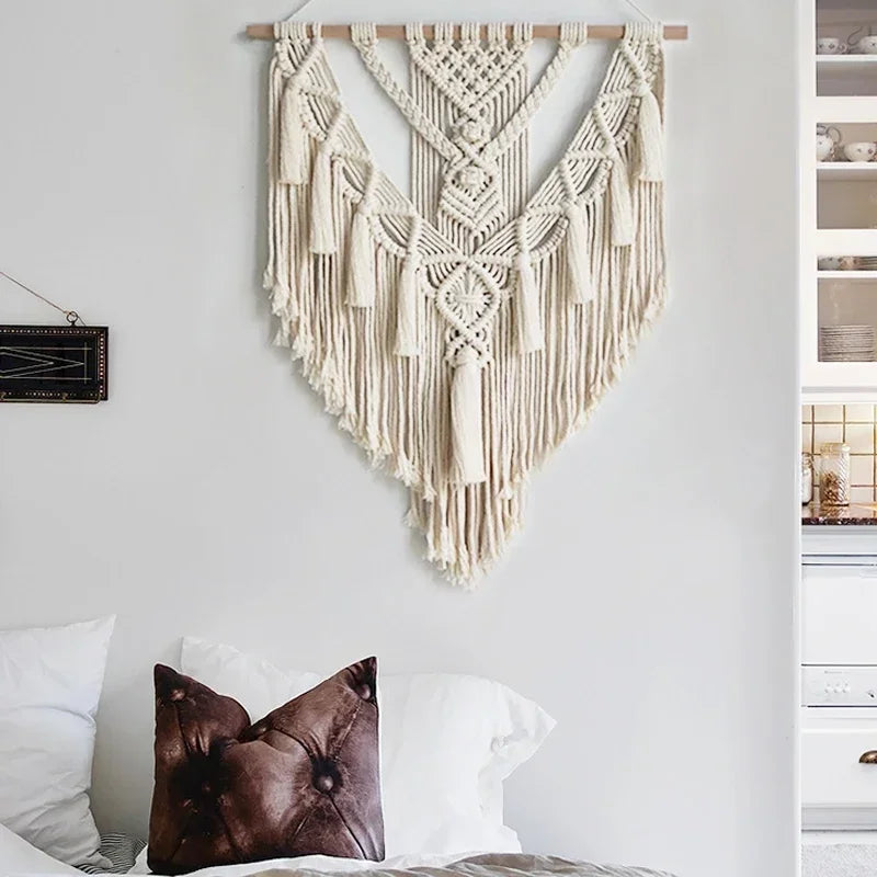 Macrame wall hanging displayed above a bed in a cozy bedroom setting