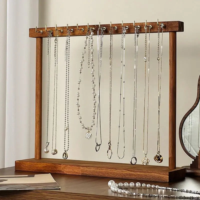Front view of wood necklace organizer holding several necklaces