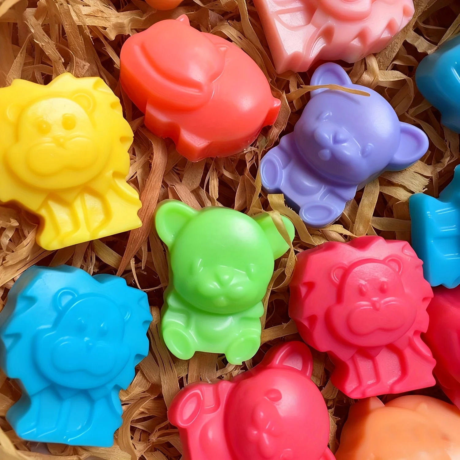 Assorted colorful 3D animal soaps made from silicone mold, displayed on a natural bedding