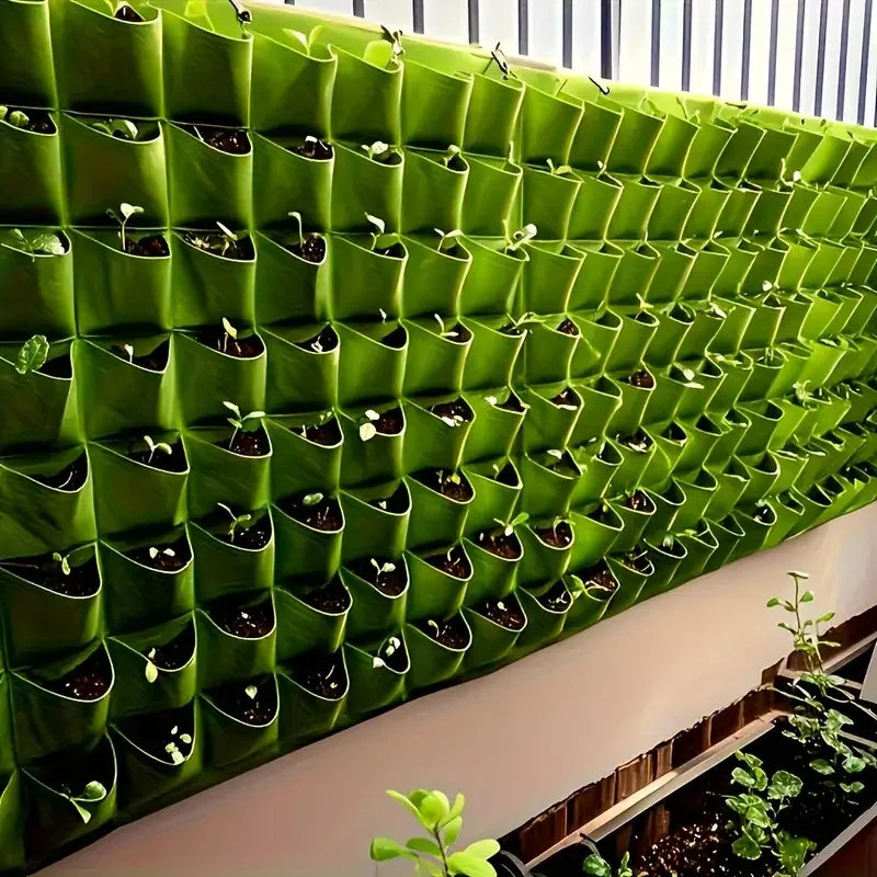 Large modular green wall of vertical planters with seedlings growing in each pocket