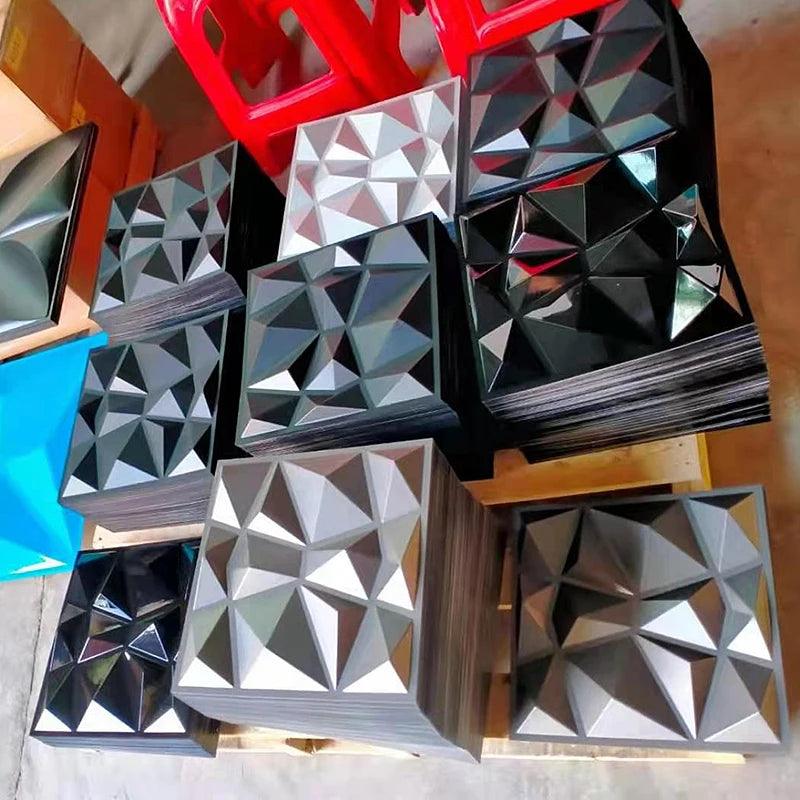 Stack of 3D geometric wall panels in various colors and finishes