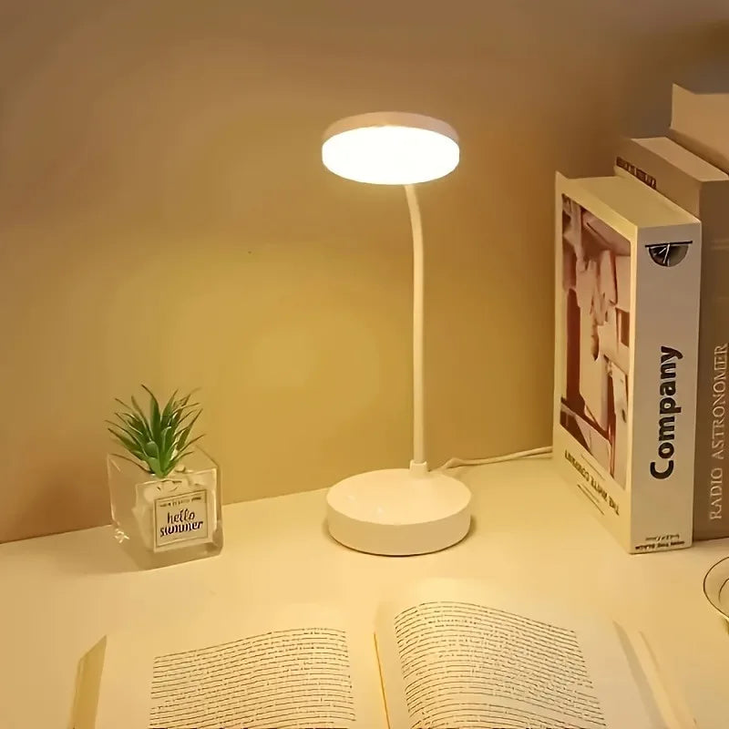 LED desk lamp illuminating a book on a tidy desk with cozy ambient light