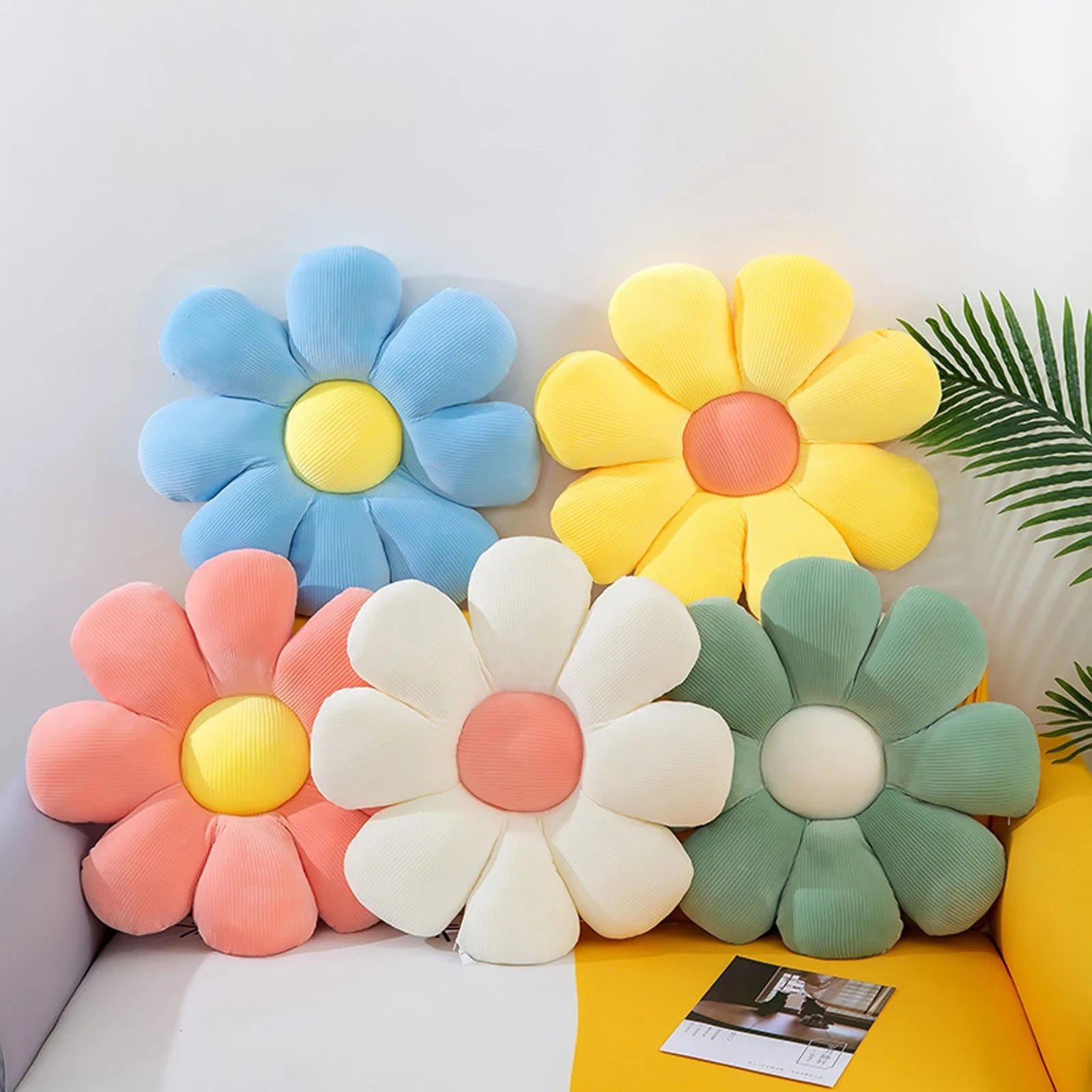 Assorted daisy flower seat cushions in six colors on bed or sofa, soft plush decor