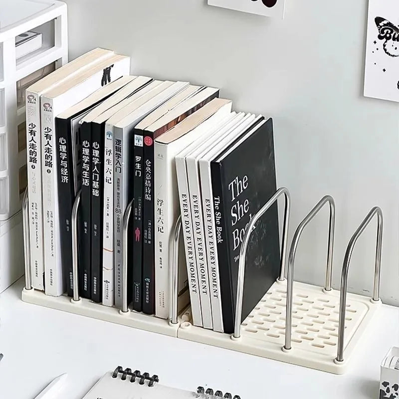 Minimalist desk bookshelf organizer in use on a white work surface, holding books upright next to a notepad