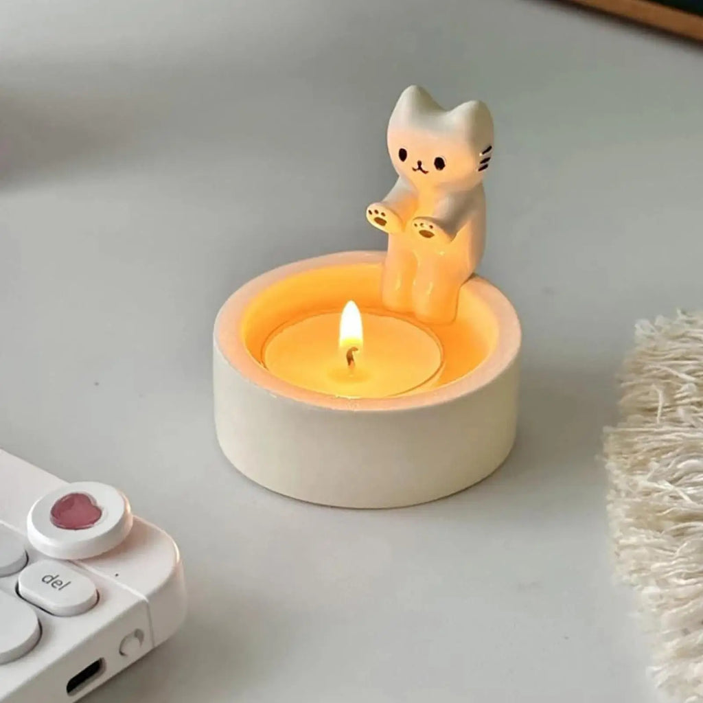 cat tealight candle holder with lit tealight on white table