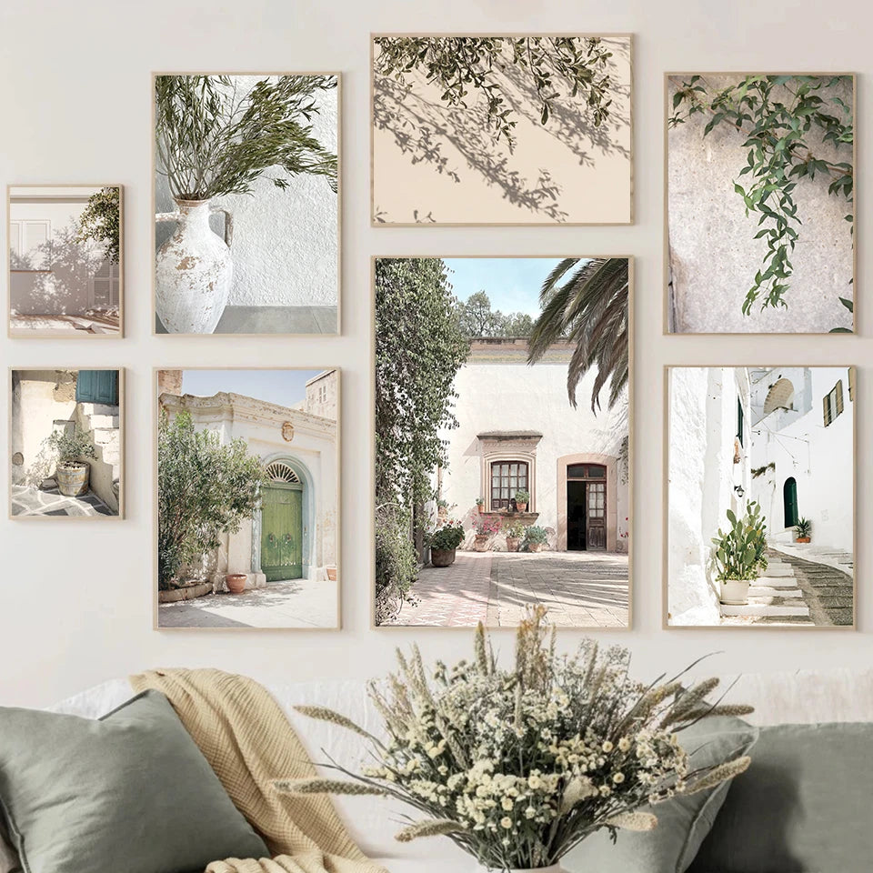 Canvas wall art prints with Spanish scenery and greenery above a sofa in a living space