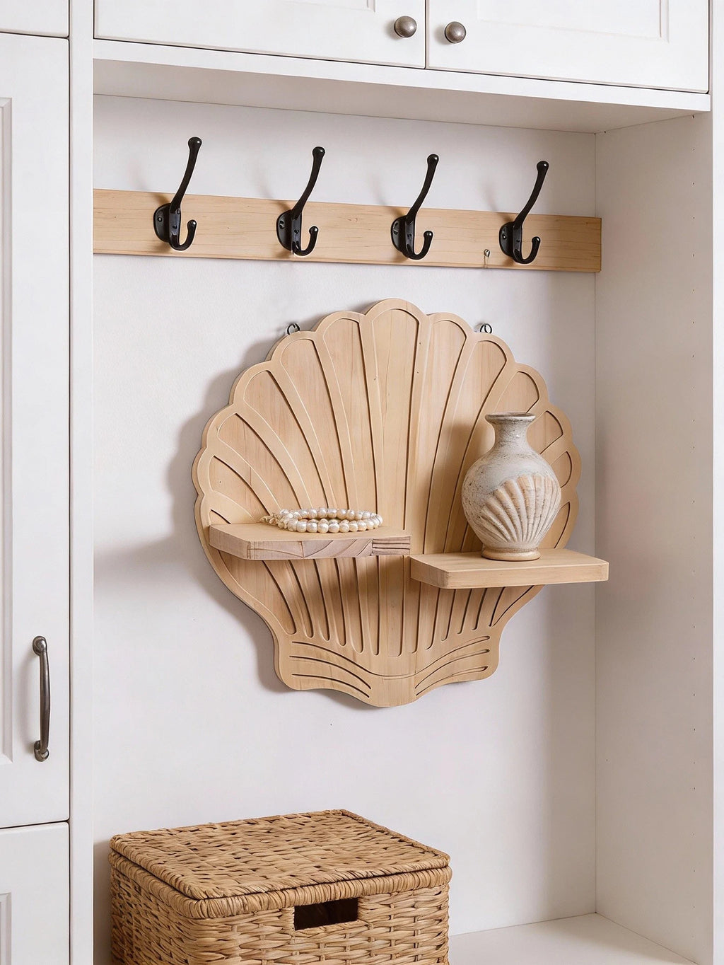Seashell design wooden wall shelf mounted in an entryway cubby with hooks and neutral woven basket—shown organizing vase and jewelry.
