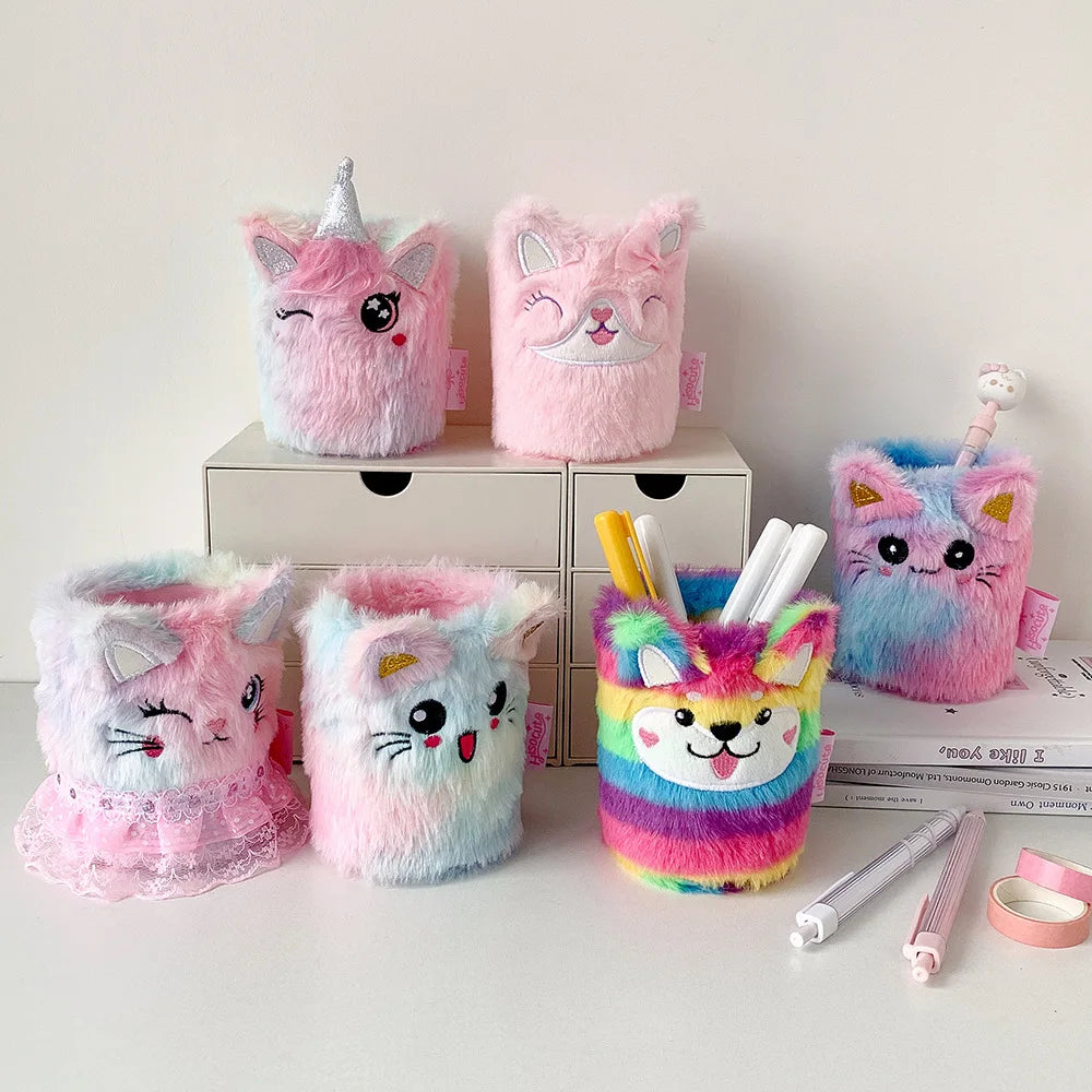 Assorted plush animal pen holders displayed on a white desk, showing unicorn, cat, dog, and multi-colored designs