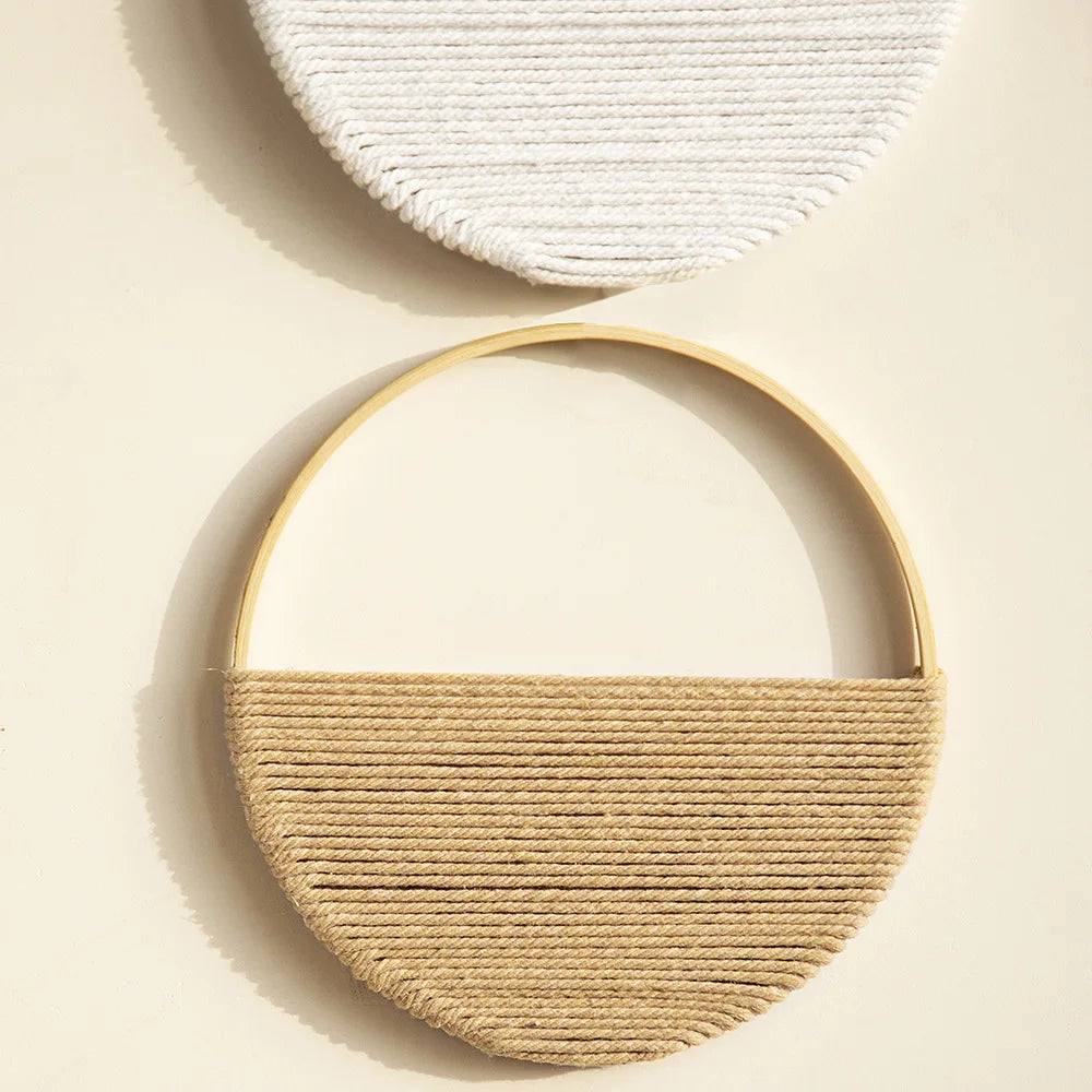Close-up of the tan round macrame wall hanging with natural cotton cord and wooden ring