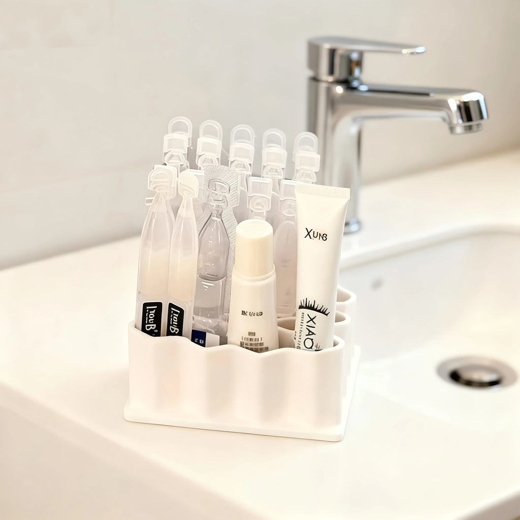 Organizer holding small cosmetics and vials beside a bathroom sink