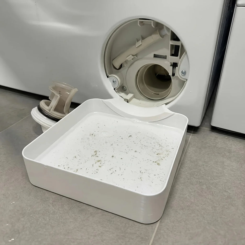 Used drainage tray catching lint and water below washing machine filter cover