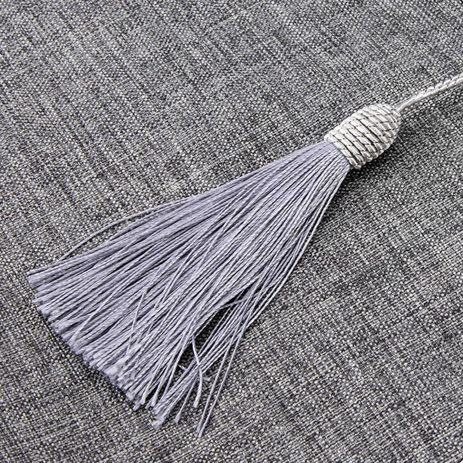 detail of gray tassel on end of linen table runner