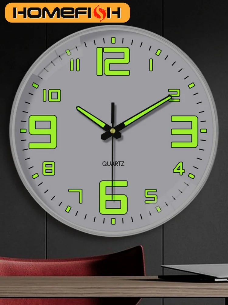 Gray wall clock with luminous green numerals and black hands above a red chair and desk