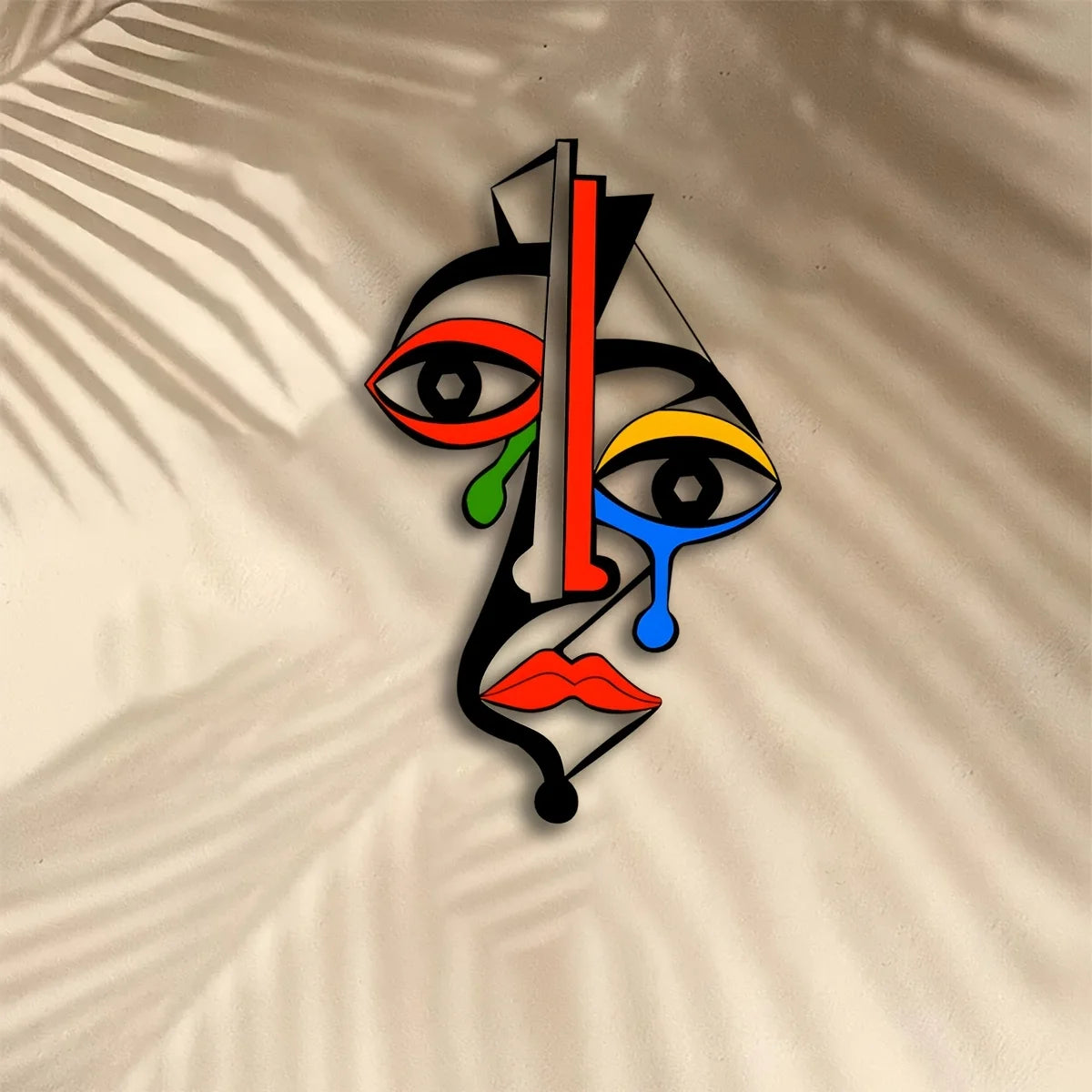 Cubist style colorful metal face wall art against a neutral backdrop with shadowed lines
