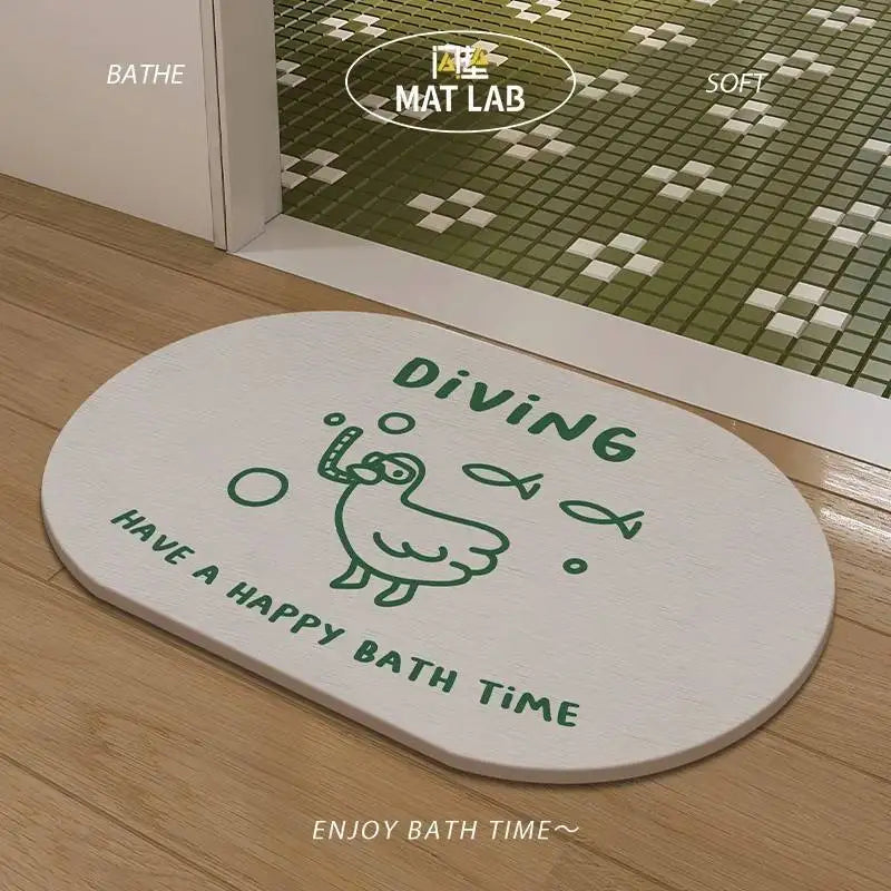 Oval white bath mat with green cartoon duck diving illustration, placed by a bathroom door