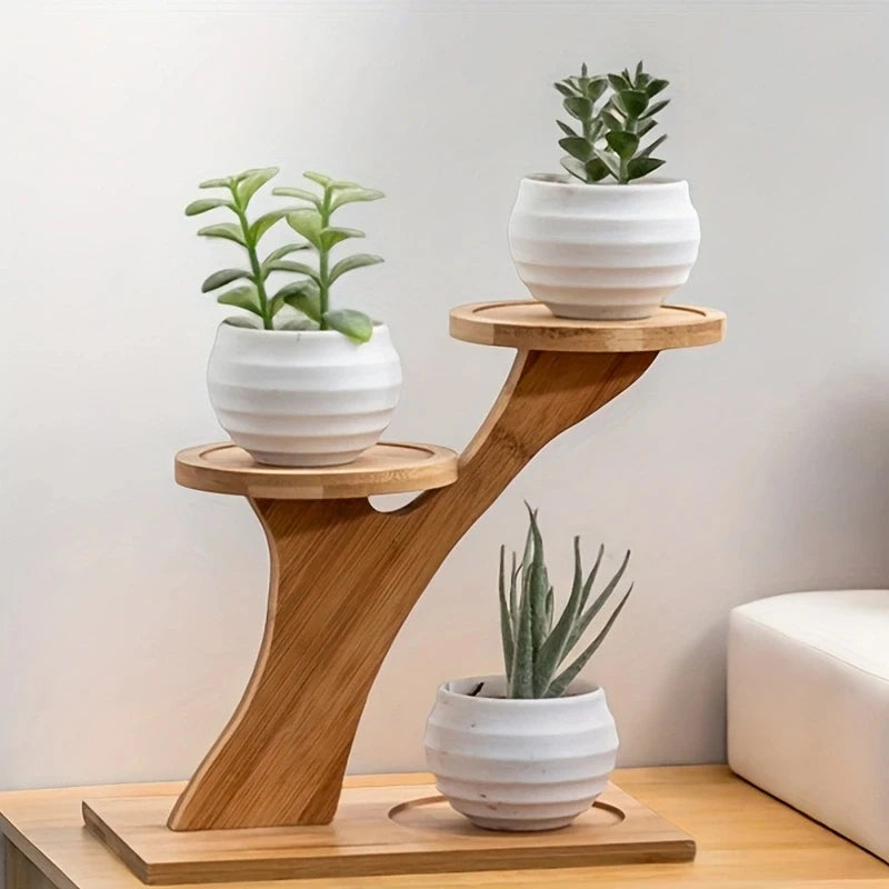 3-tier mini plant stand with white round pots on a wood desk